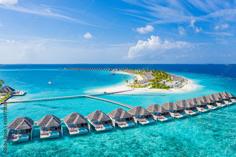 Perfect aerial landscape, luxury tropical resort or hotel with water villas and beautiful beach scenery. Amazing bird eyes view in Maldives, landscape seascape aerial view over a Maldives - obrazy, fototapety, plakaty 