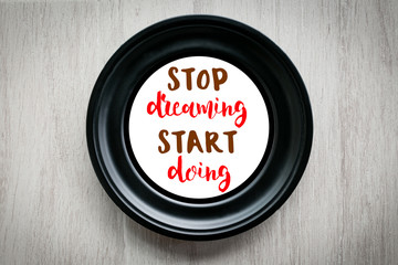 Wall Mural - Motivational quote to create future, Stop dreaming start doing words on black circle picture flame. 
