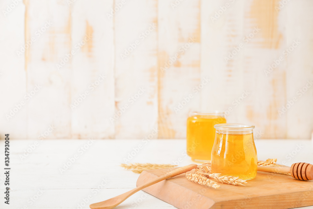 Jar of sweet honey on table