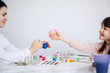 © Oleksandr - Happy Easter concept. Family preparing for Easter celebration. Art and craft concept with female hands and paiting eggs by girls