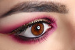 © H_Ko - Close-up of model charming eye. Professional makeup in burgundy colors with golden glitters. Perfect eyebrow shape. Art of evening maquillage. Beauty and cosmetics concept