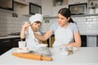 © Serhii - Son and mother preparing dough together