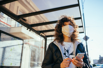 Worried young woman wearing medical face mask