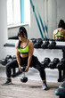 © nazariykarkhut - Sporty girl doing exercise with dumbbells in the gym. Active lifestyle