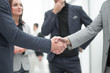 © ASDF - handshake of young business partners. the concept of cooperation