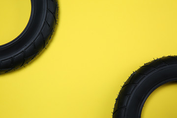 Sticker - Bicycle tires on yellow background, flat lay. Space for text