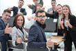 © ASDF - group of young professionals showing thumbs up