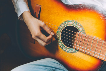 Stay Home Stay Safe. Young woman sitting at home and playing guitar, hands close up. Teen girl learning to play song and writing music. Hobby lifestyle relax Instrument leisure education concept.