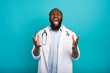 © alphaspirit - Exhausted doctor with lab coat and stethoscope screams on cyan background