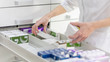 © Aliaksandr - Pharmacist holding medicine box and capsule pack in pharmacy drugstore.