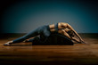 © Georgii - Pilates, fitness, sport, training and people concept - woman doing exercises on a small barrel. Fitness concept, low key, gray background, copy space, art light.