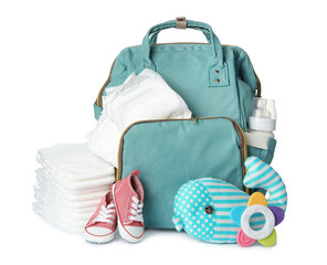 Wall Mural - backpack with disposable diapers and child's accessories on white background