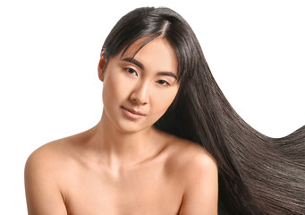 Young Asian woman with beautiful long hair on white background