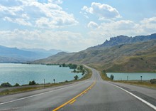 Wide Scenic Drive Along North Fork Highway With The Buffalo Bill Reservoir And Dam Along The Road.