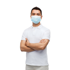 health, quarantine and pandemic concept - young man wearing protective medical mask for protection from virus disease over grey background