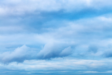 Wall Mural - low dark blue clouds in spring evening sky