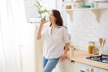 Gorgeous Woman Drinking Water In Her Kitchen