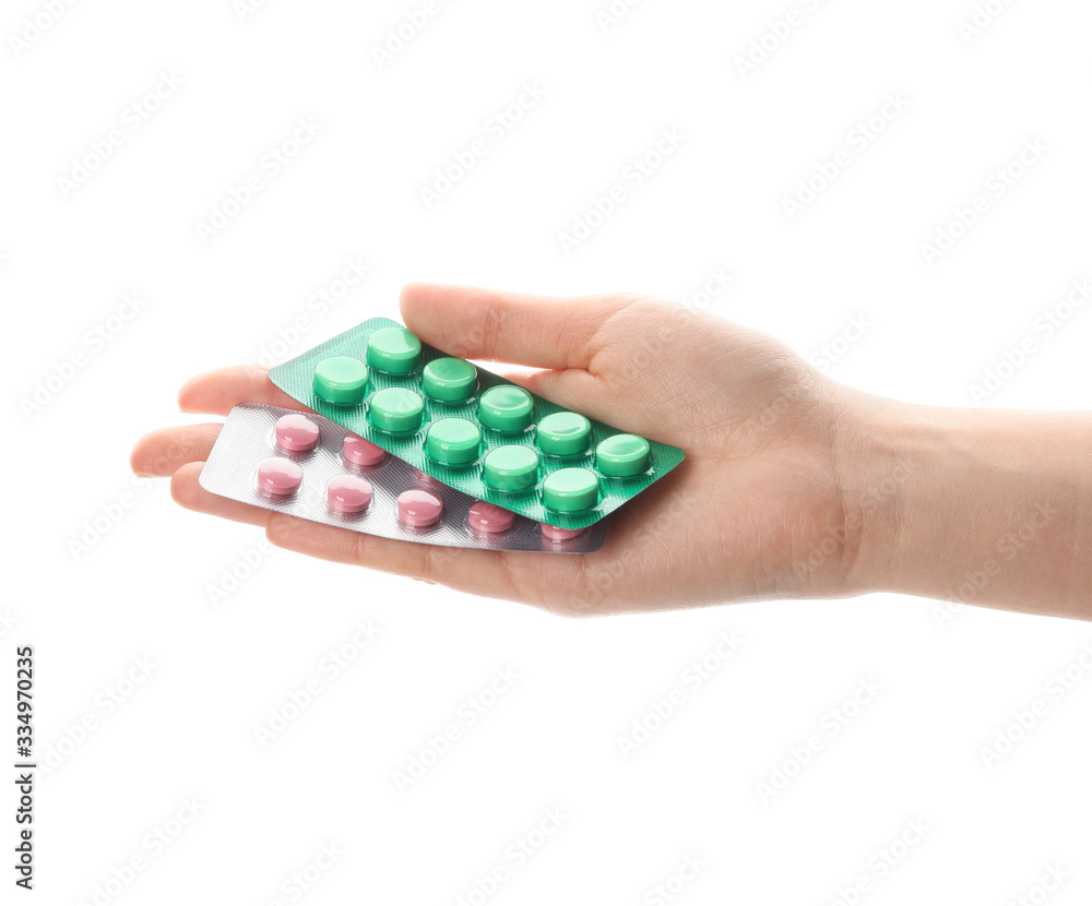Female hand with pills on white background