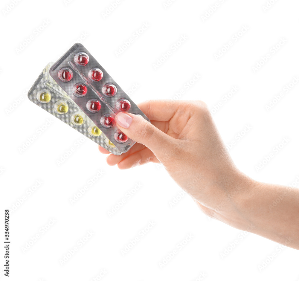 Female hand with pills on white background