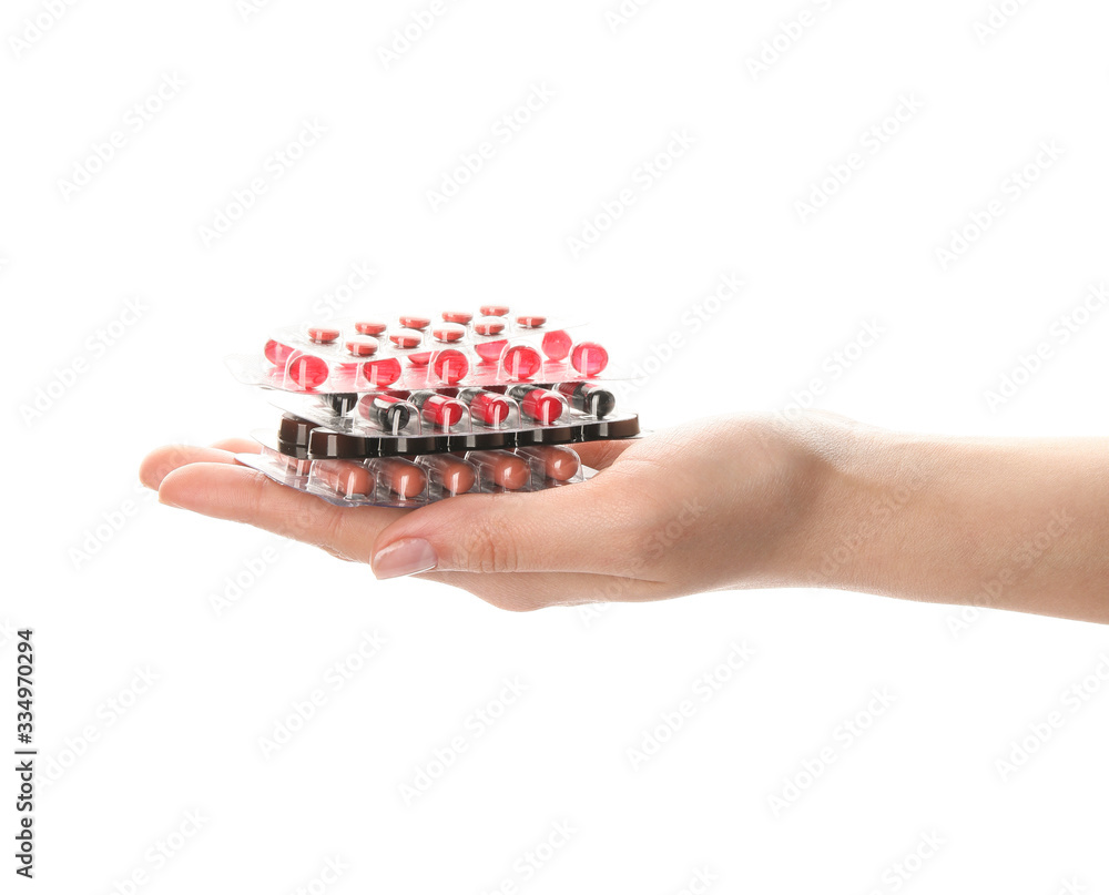 Female hand with pills on white background