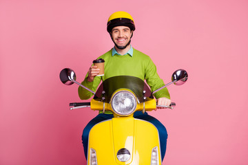 Wall Mural - Portrait of his he nice attractive confident cheerful cheery glad guy sitting on moped drinking hot sweet cacao good morning pastime isolated over pink pastel color background