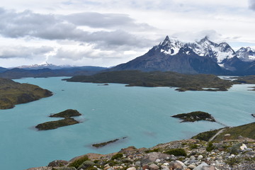 Wall Mural - 
Snow covered mountains with the light blue ocean in front in Torres del Paine National Park in Chile, Patagonia
