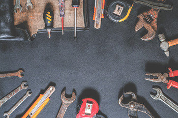 Tools for repair and reconstruction in home conditions lie on a black background