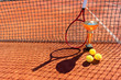 © Elena - Trophy, professional tennis racket and balls on a red clay tennis court and net shadow. Champion or victory cup, tennis balls and racket on the court. Background. Winning concept. Copy space