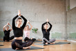 © serhiibobyk - Group of women doing yoga in hall.
