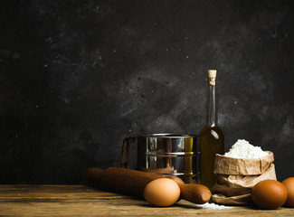 Cooking and baking background. Old kitchen with products and ingredients (flour, butter, eggs) for dough and baking bread, pasta and pizza