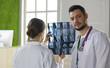 © lenetsnikolai - Team of doctors watching x-ray image in a hospital