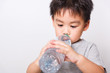 © sorapop - Closeup Asian face, Little children boy drinking water from Plastic bottle