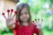 © olsima - Young girl is holding raspberries on her fingers, outdoor shoot