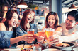 © Tom Wang - happy young group dining and drinking beer at restaurant
