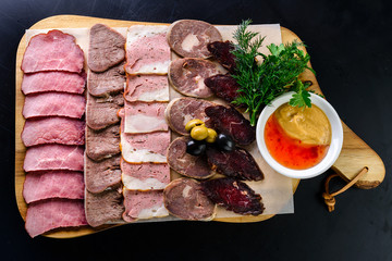 Wall Mural - Set mix jerky, sausage, salami and bacon served on a wooden board