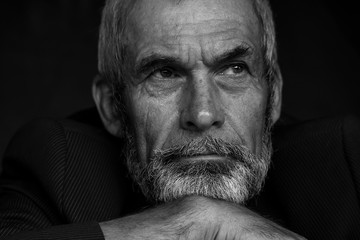 Fabulous at any age concept. Close up portrait of handsome mature man with beard and moustache. Monochrome indoor shot. Closed on quarantine. Text space.