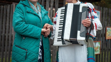 Women Friendship. Friendly handshake of two women..clothes. Folk music. Traditional autumn harvest festival. People and traditions.