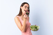 © luismolinero - Young woman with salad over isolated wall