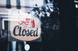 © Maderla - Sorry we're closed sign. grunge image hanging on a dirty glass door.