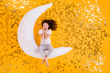 Sticker - Sweet dreams concept. Full body high angle above flat lay view photo of funny little lady lying floor many sparkling stars moon pillow wear pajama isolated yellow color background