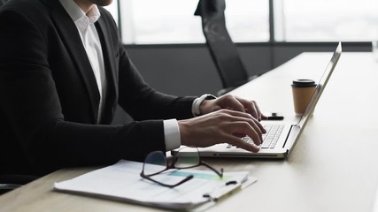 Businessman working on computer. Man using laptop in the office. Internet marketing, finance, business concept