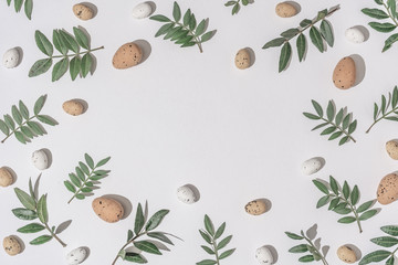 Wall Mural - Creative flat lay composition with easter eggs and natural branches. Natural sun light lighting and sharp shadows. Realistic aesthetic look pattern. Contemporary style.