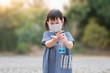 © apiwat - Cute Asian girls wear masks to protect against covid-19 viruses and Pm2.5 air pollution and wash their hands with alcohol gel to protect against covid-19 virus outbreak. Coronavirus concept.
