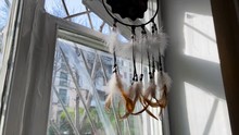 View Of A Dream Catcher Hanging In A Window