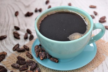 cup of coffee with beans and cinnamon