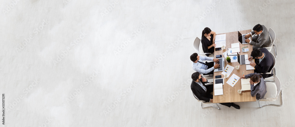 Top view of group of multiethnic busy people working in an office, Aerial view with businessman and businesswoman sitting around a conference table with blank copy space, Business meeting concept - obrazy, fototapety, plakaty 