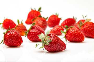 Wall Mural - Strawberries with leaves isolated on white background