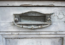 Close Up Of Old Mail Slot In Wooden Door