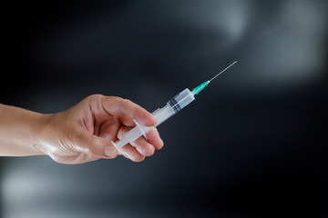 Syringe and vial human hand about to make vaccine