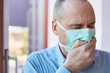 Covid-19 patient with face mask when coughing in hand